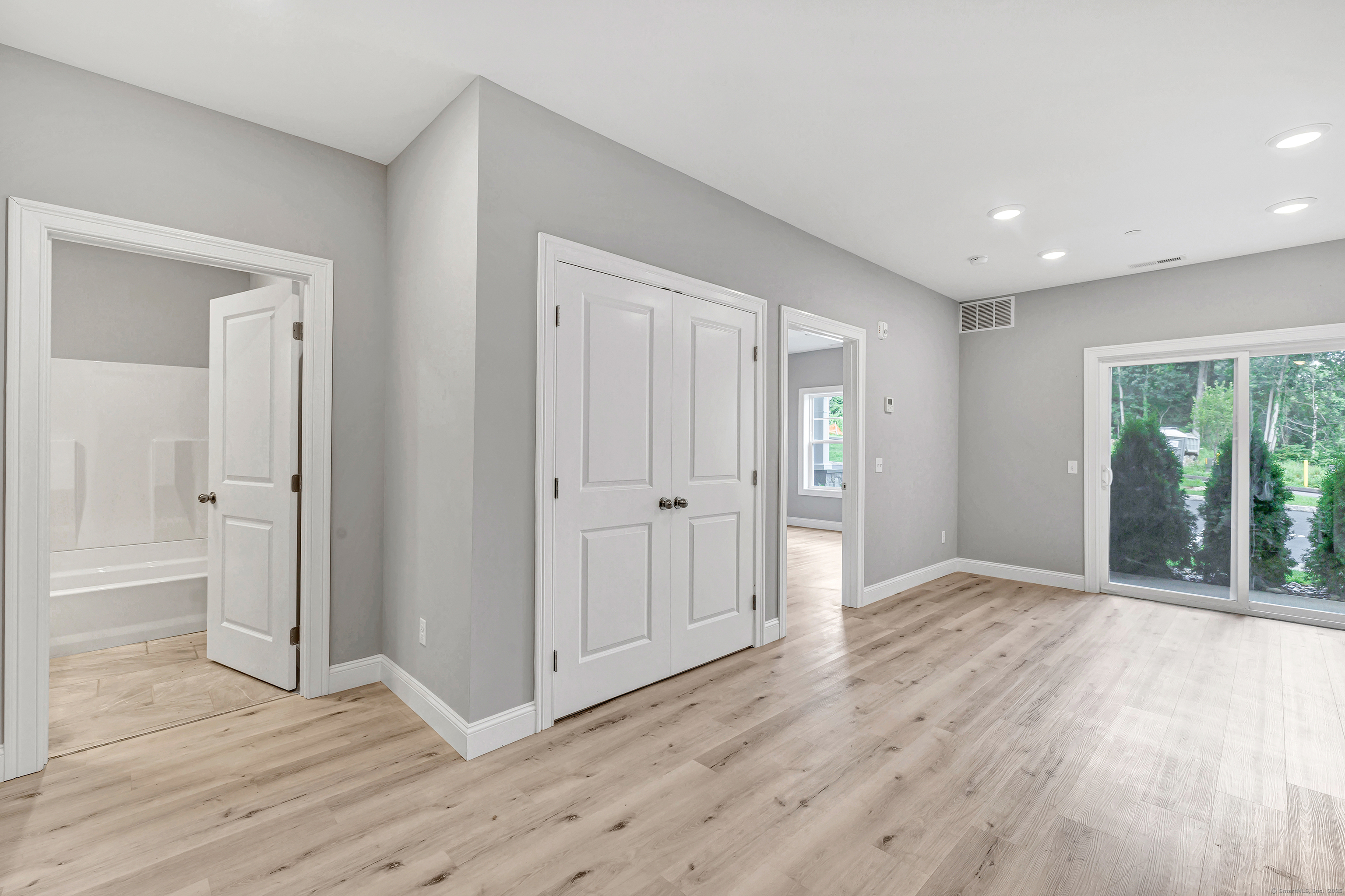 303 Bridgeport Avenue, Unit 205 Shelton, CT 06484 - Photo 29 of 36 a view of an empty room with wooden floor and a window