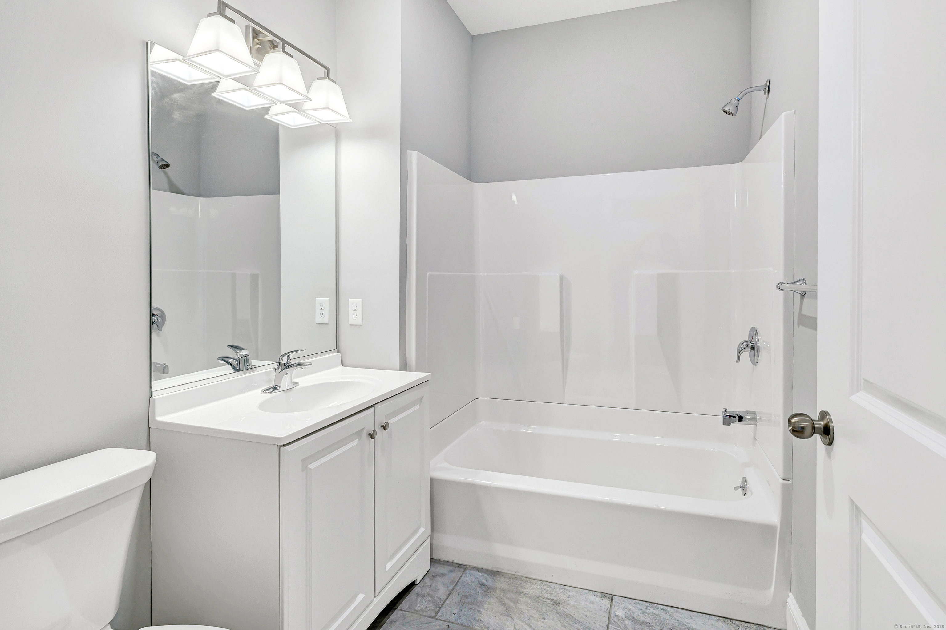 303 Bridgeport Avenue, Unit 205 Shelton, CT 06484 - Photo 31 of 36 a bathroom with a sink a toilet and shower