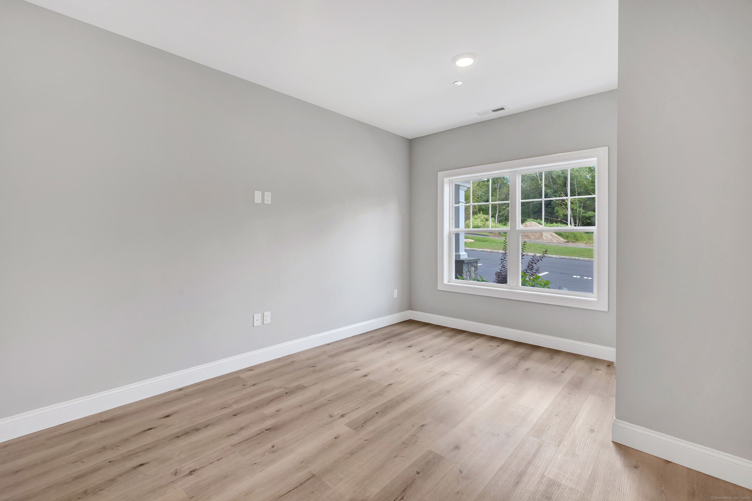 303 Bridgeport Avenue, Unit 205 Shelton, CT 06484 - Photo 32 of 36 wooden floor in an empty room with a window