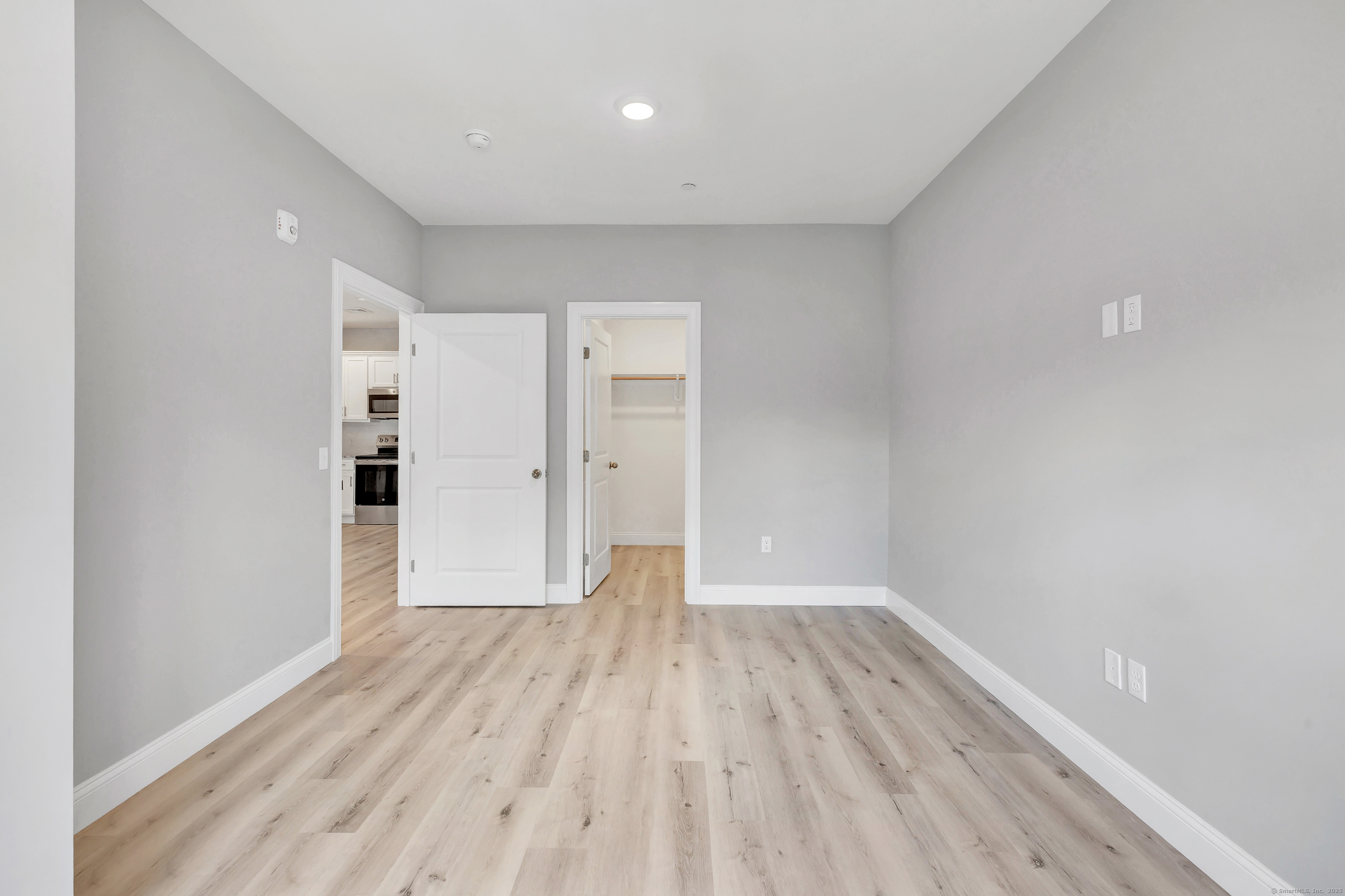 303 Bridgeport Avenue, Unit 205 Shelton, CT 06484 - Photo 34 of 36 a view of wooden floor and windows in a room