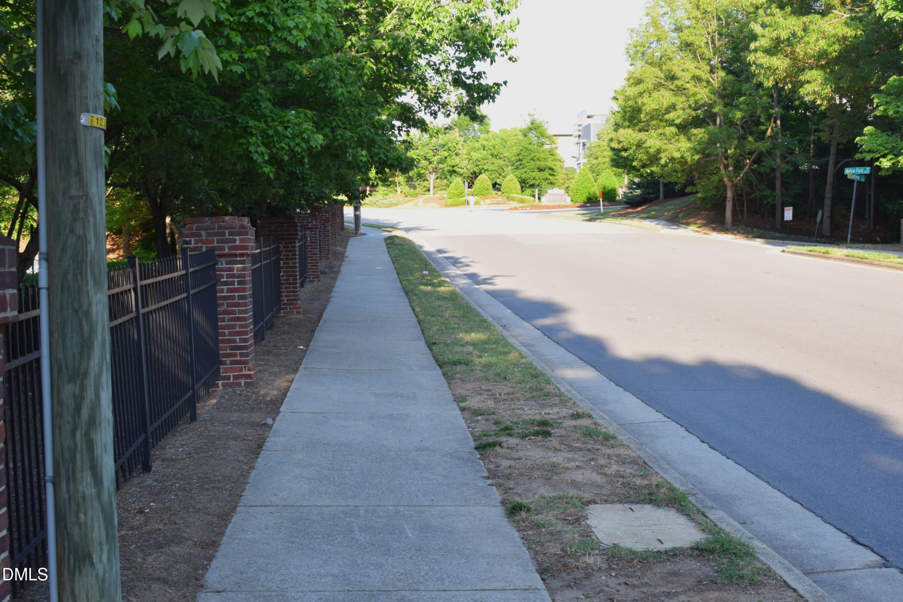 2651 Mellowfield Drive, Unit 203 Raleigh, NC 27604 - Photo 28 of 32 a view of a pathway with a wrought fence
