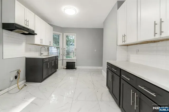 a kitchen with stainless steel appliances granite countertop a sink and cabinets