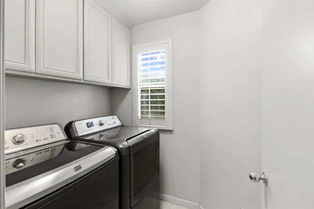 a view of an empty room with wooden floor fireplace and a window