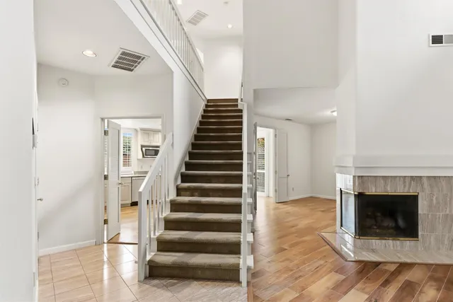 a view of a hallway with wooden floor and windows