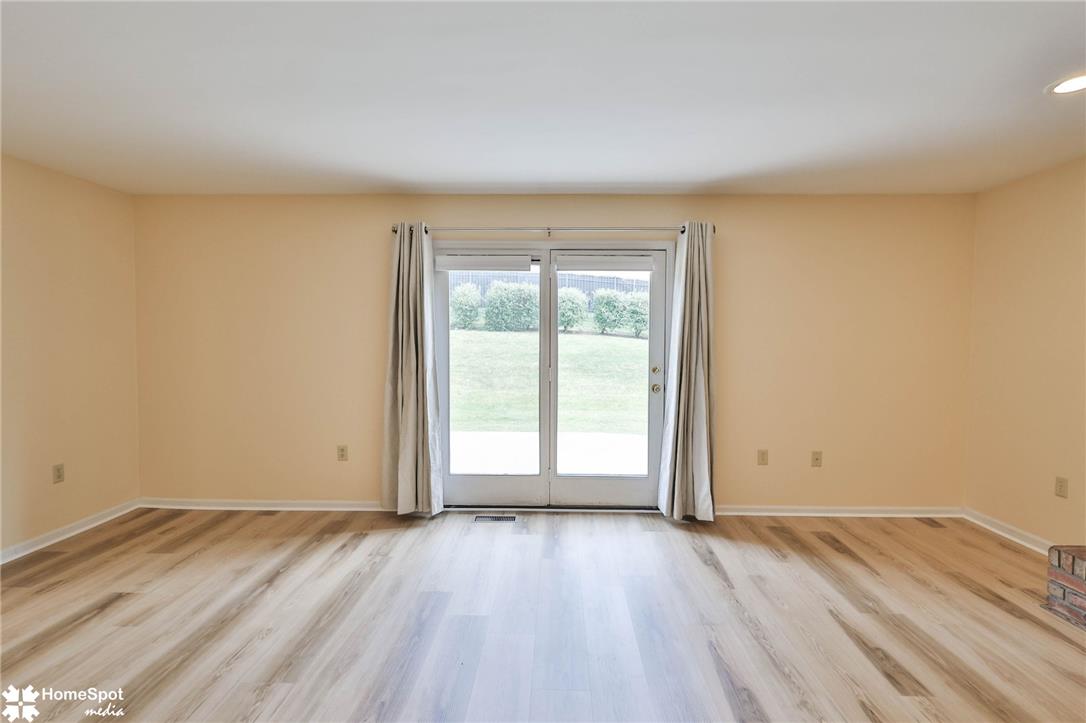 4059 Wedgewood Road Allentown, PA 18104 - Photo 25 of 72 Floor-to-ceiling glass doors open to a generous outdoor expanse, inviting nature indoors.