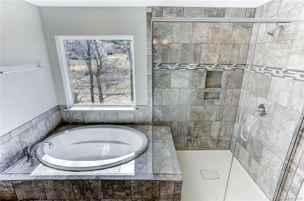 246 Hydrangea Drive Clover, SC 29710 - Photo 22 of 24 a bathroom with a sink a window and a bathtub