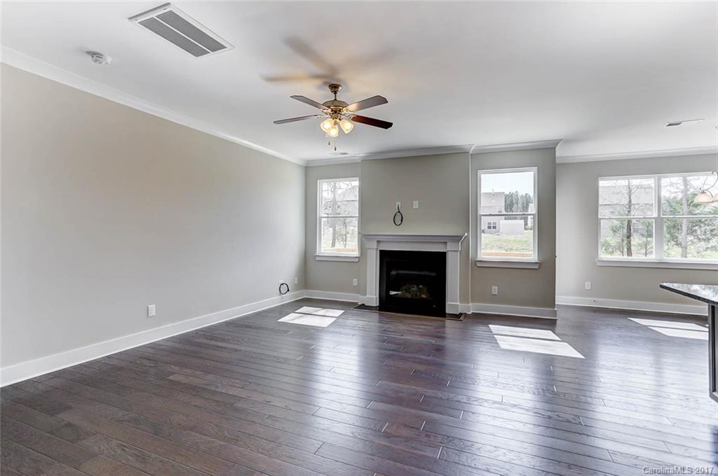 246 Hydrangea Drive Clover, SC 29710 - Photo 8 of 24 an empty room with wooden floor fireplace and windows