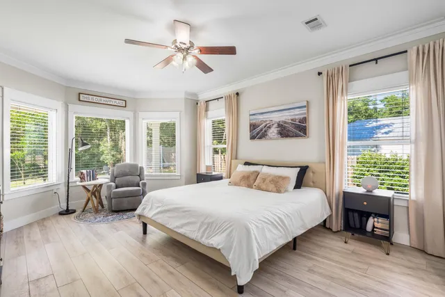 a bedroom with a bed and a chandelier