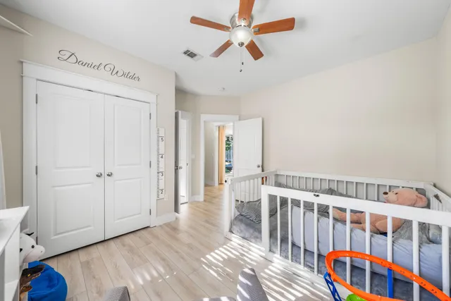 a bedroom with a large bed and a chandelier