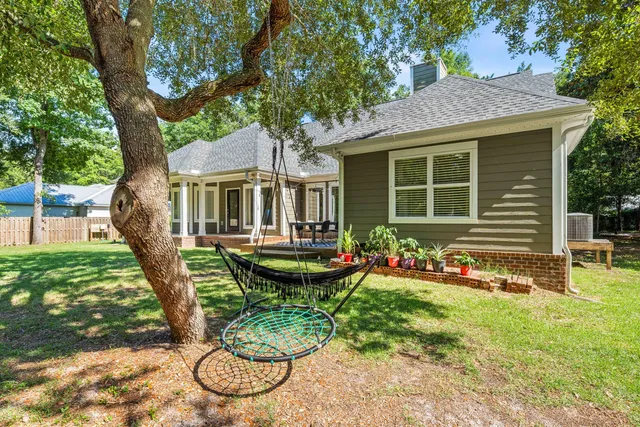 a view of a house with a yard and sitting area