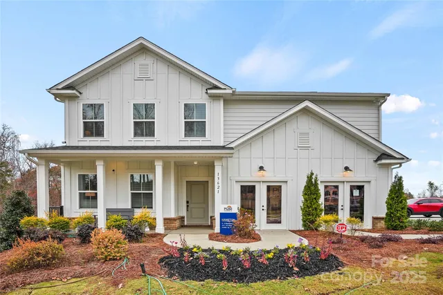 a front view of a house with a yard table and chairs
