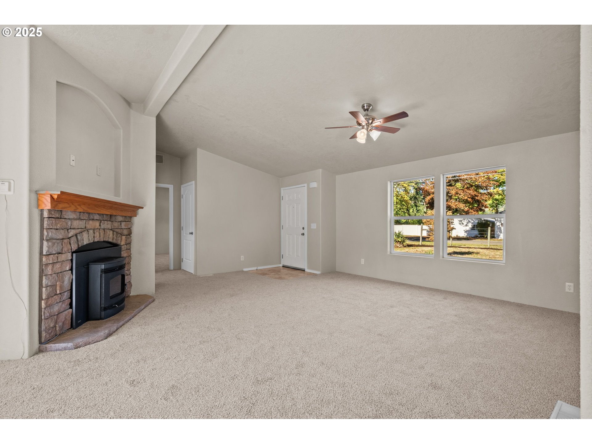 344 Southwest Ivy Street Mill City, OR 97360 - Photo 5 of 38 a view of an empty room with window and a fireplace