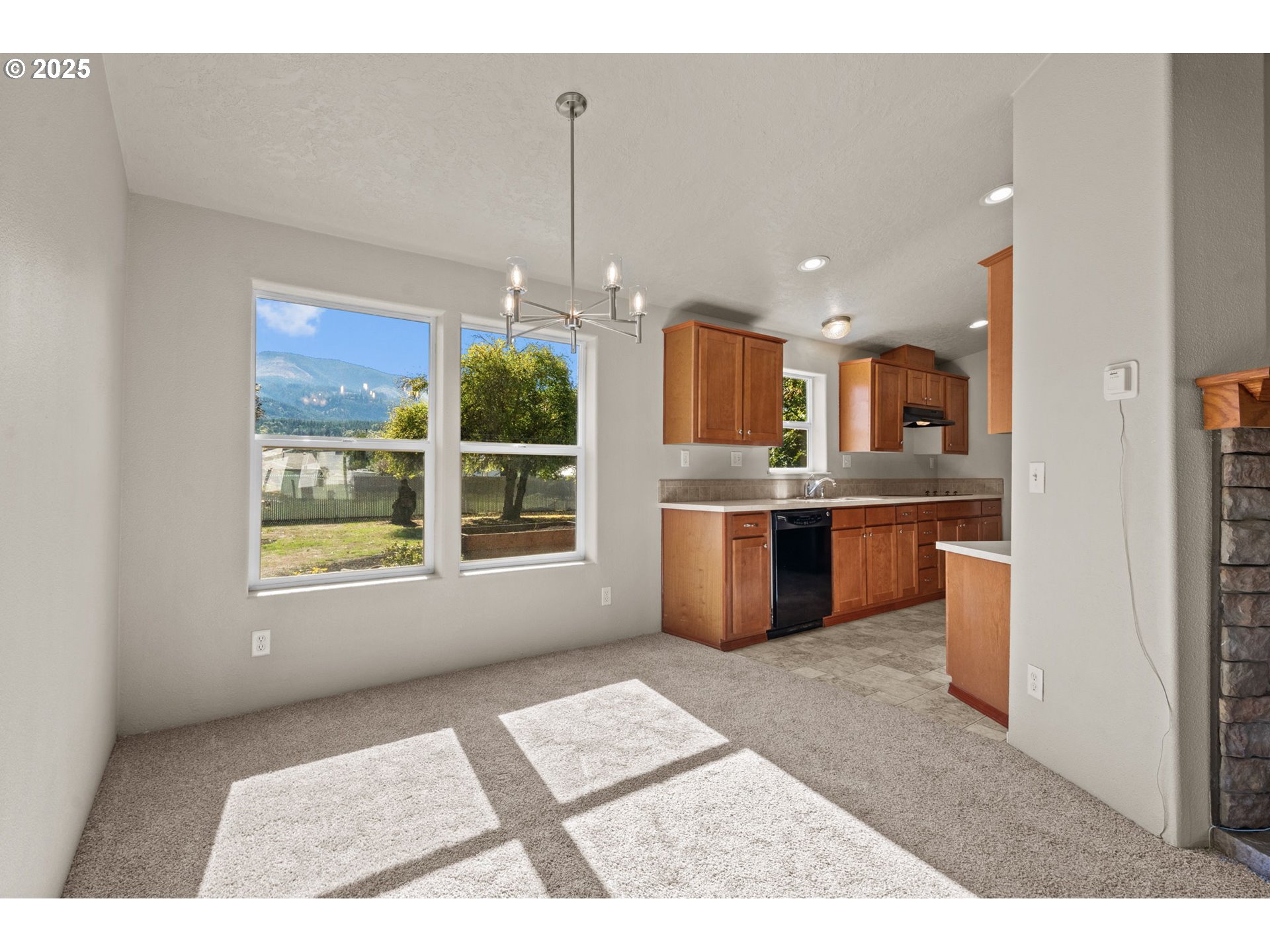 344 Southwest Ivy Street Mill City, OR 97360 - Photo 9 of 38 a open kitchen with kitchen island granite countertop a sink window and stainless steel appliances