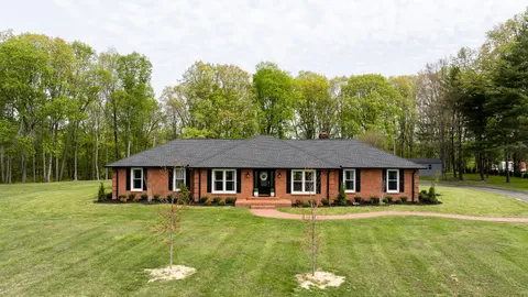 a front view of a house with a garden