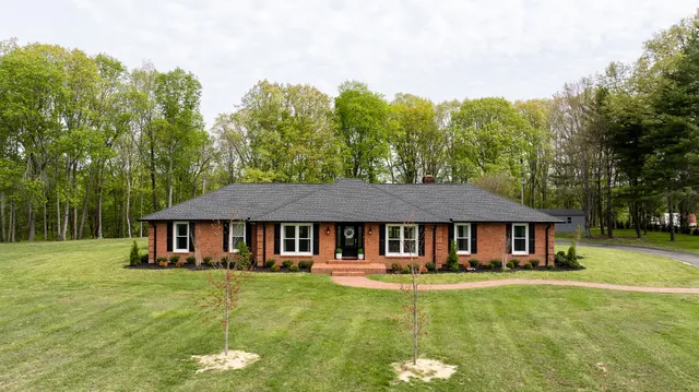 a front view of a house with a garden