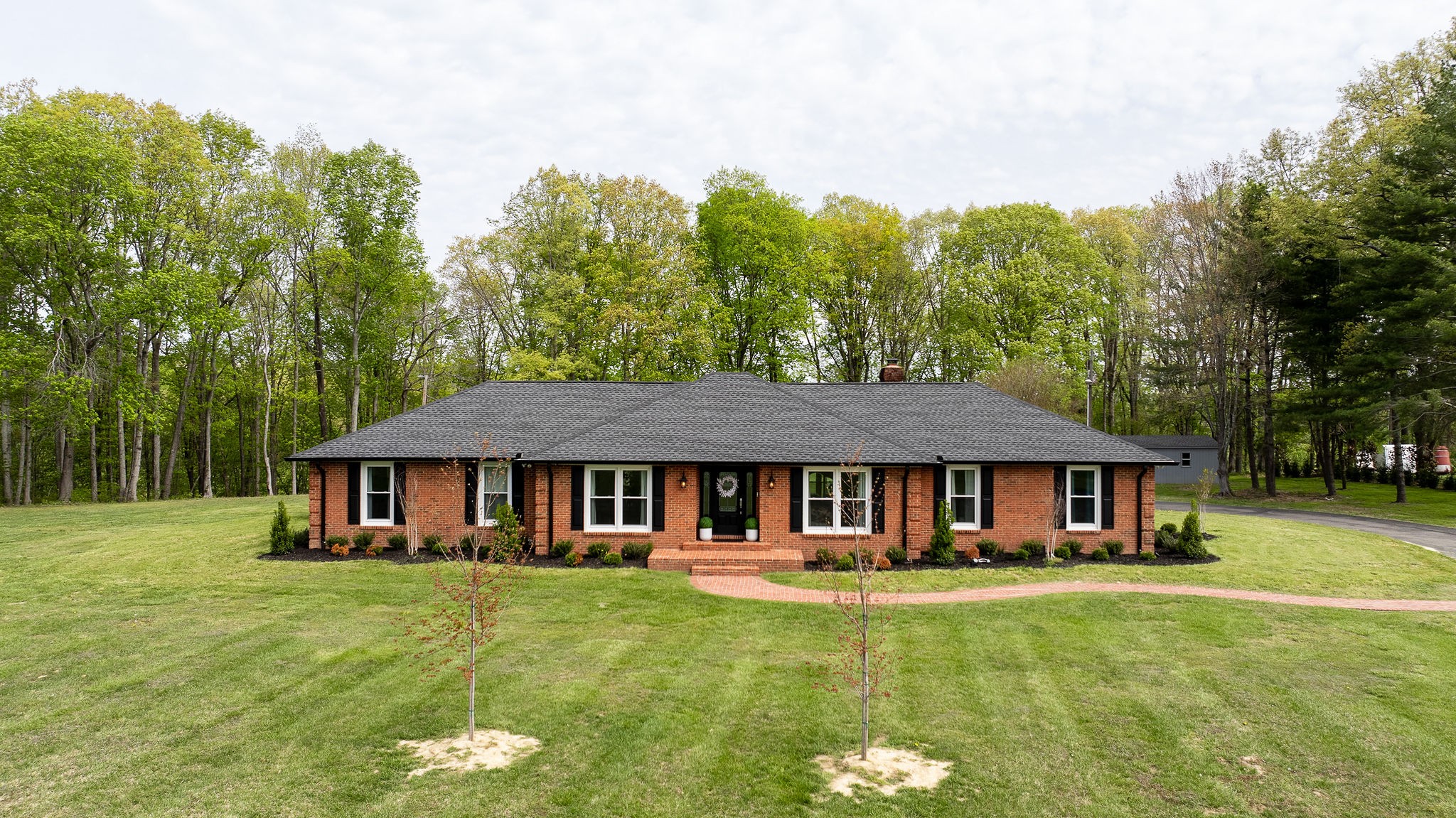 a front view of a house with a garden
