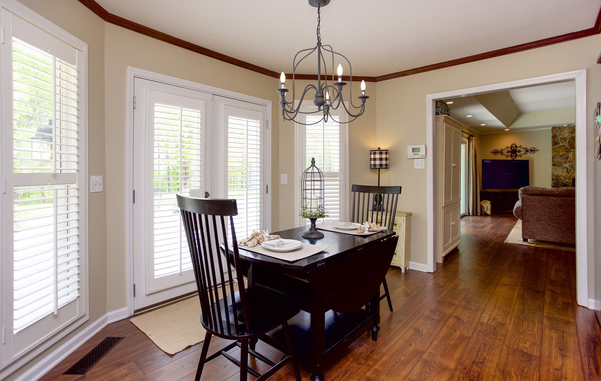 1747 Allen Ferry Road Smithville, TN 37166 - Photo 15 of 45 a dining room with wooden floor a chandelier a wooden table and chairs