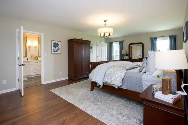 a bedroom with a bed and a chandelier