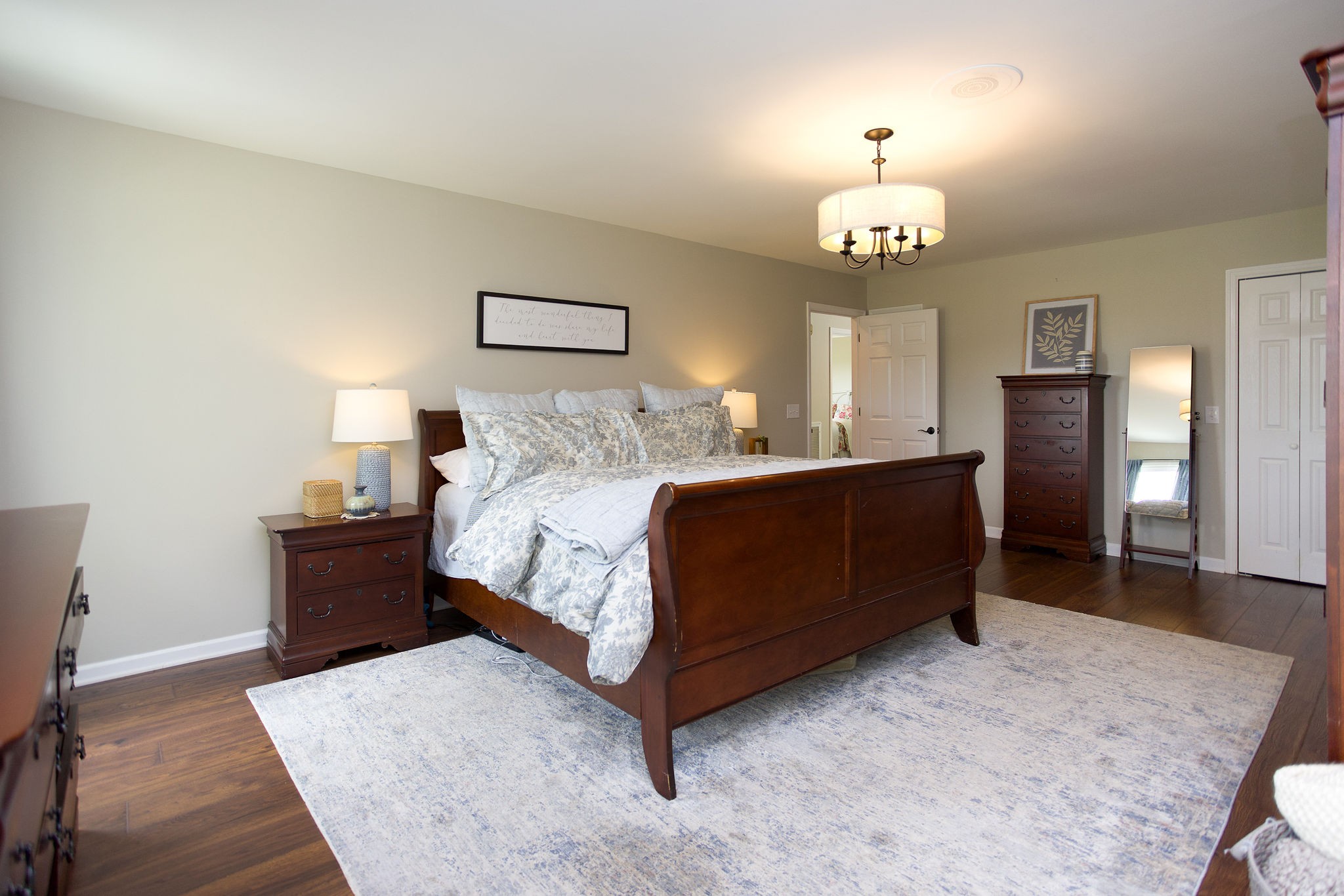 1747 Allen Ferry Road Smithville, TN 37166 - Photo 17 of 45 a bedroom with a bed and a chandelier