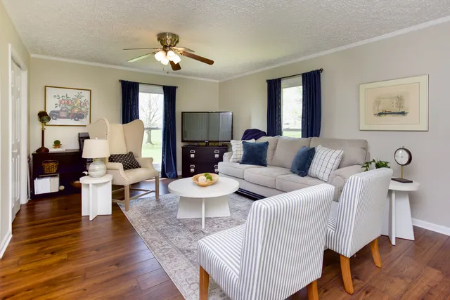 a living room with furniture and wooden floor