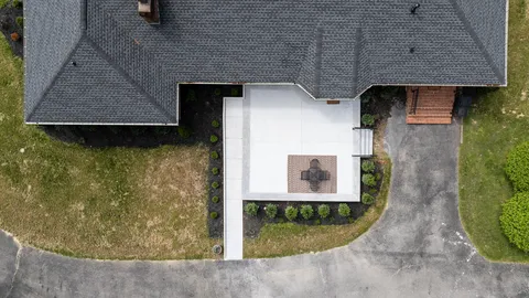 an aerial view of a residential houses with outdoor space