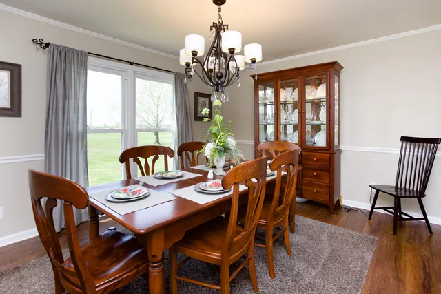 a view of a dining room with furniture wooden floor and chandelier