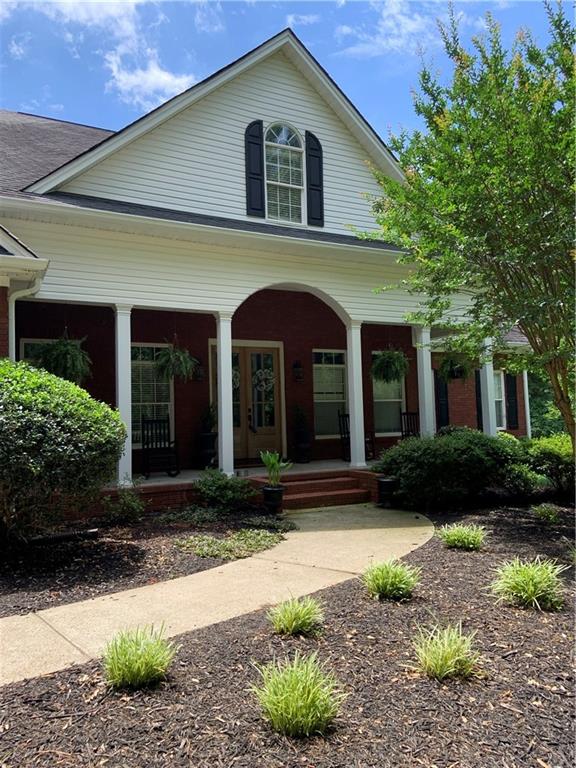 656 Hickory Grove Church Road Monroe, GA 30656 - Photo 1 of 1 a front view of a house with garden