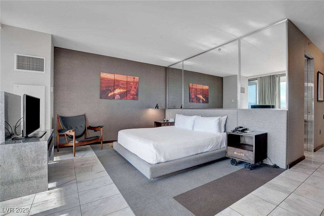 4381 West Flamingo Road, Unit 1121 Las Vegas, NV 89103 - Photo 13 of 33 Bedroom featuring marble finish flooring and track lighting