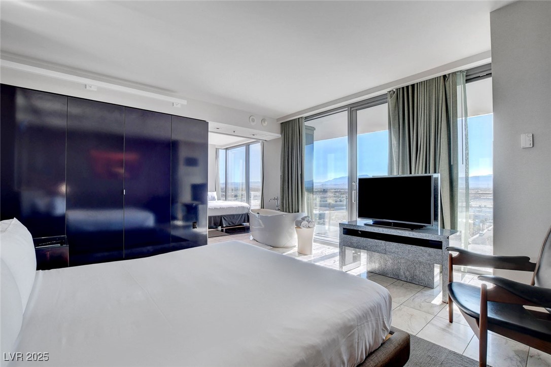 4381 West Flamingo Road, Unit 1121 Las Vegas, NV 89103 - Photo 15 of 33 Bedroom featuring access to outside