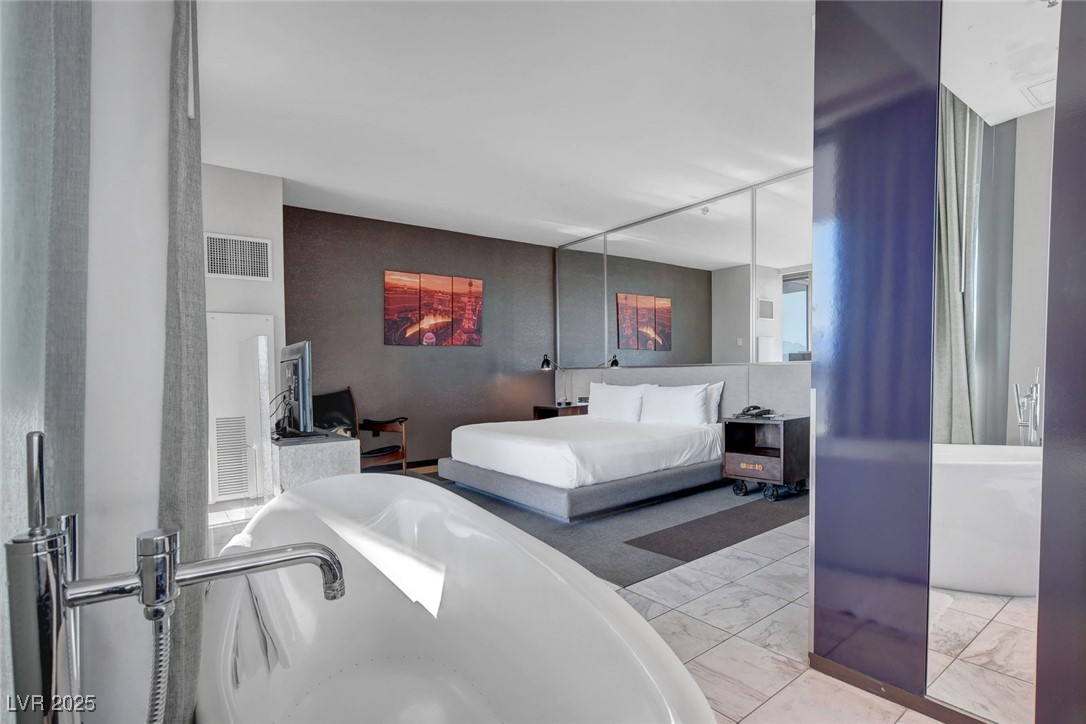 4381 West Flamingo Road, Unit 1121 Las Vegas, NV 89103 - Photo 16 of 33 Bedroom featuring marble finish floors