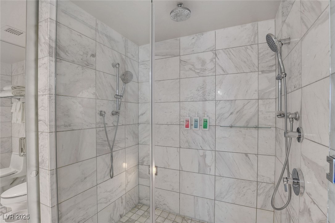 4381 West Flamingo Road, Unit 1121 Las Vegas, NV 89103 - Photo 19 of 33 Full bathroom featuring toilet and a shower stall