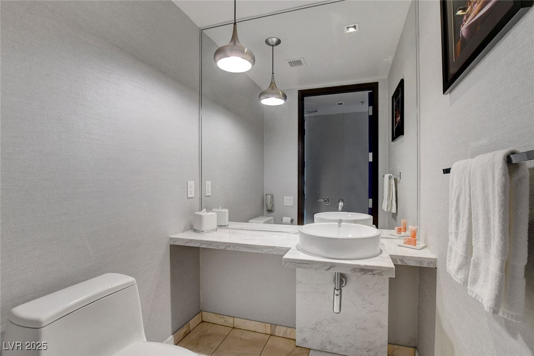 4381 West Flamingo Road, Unit 1121 Las Vegas, NV 89103 - Photo 20 of 33 Bathroom featuring tile patterned flooring, toilet, and vanity
