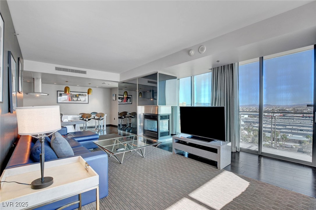 4381 West Flamingo Road, Unit 1121 Las Vegas, NV 89103 - Photo 9 of 33 Living area with plenty of natural light and wood finished floors