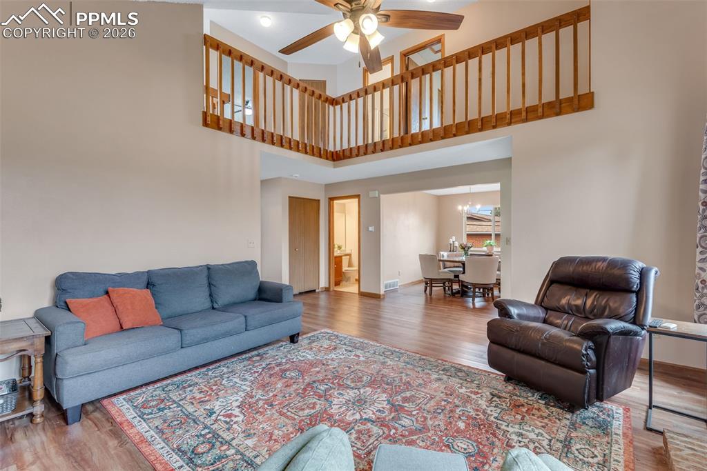 110 Monk Street Colorado Springs, CO 80911 - Photo 11 of 34 a living room with furniture stairs and a ceiling fan