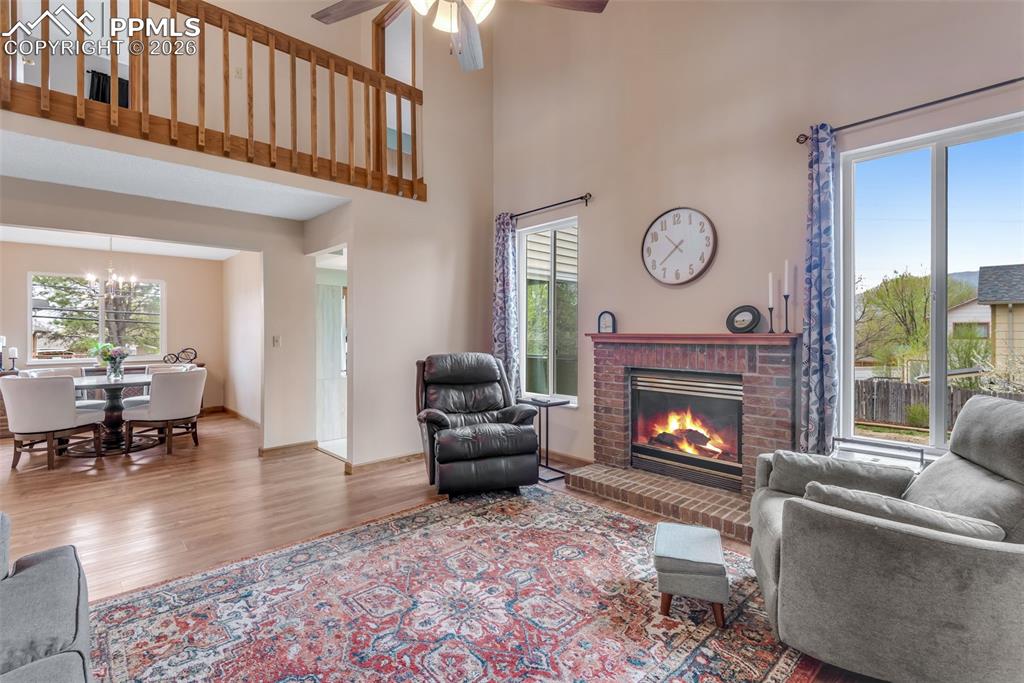110 Monk Street Colorado Springs, CO 80911 - Photo 12 of 34 a living room with furniture a window and a fireplace