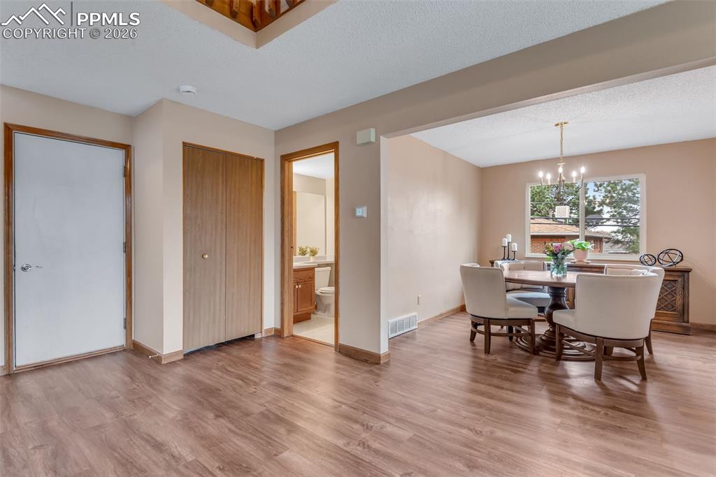 110 Monk Street Colorado Springs, CO 80911 - Photo 13 of 34 a dining room with furniture and wooden floor