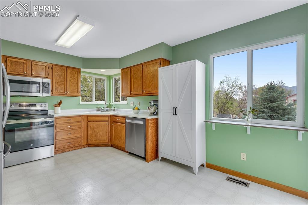 110 Monk Street Colorado Springs, CO 80911 - Photo 15 of 34 a kitchen with stainless steel appliances granite countertop a refrigerator and a stove top oven