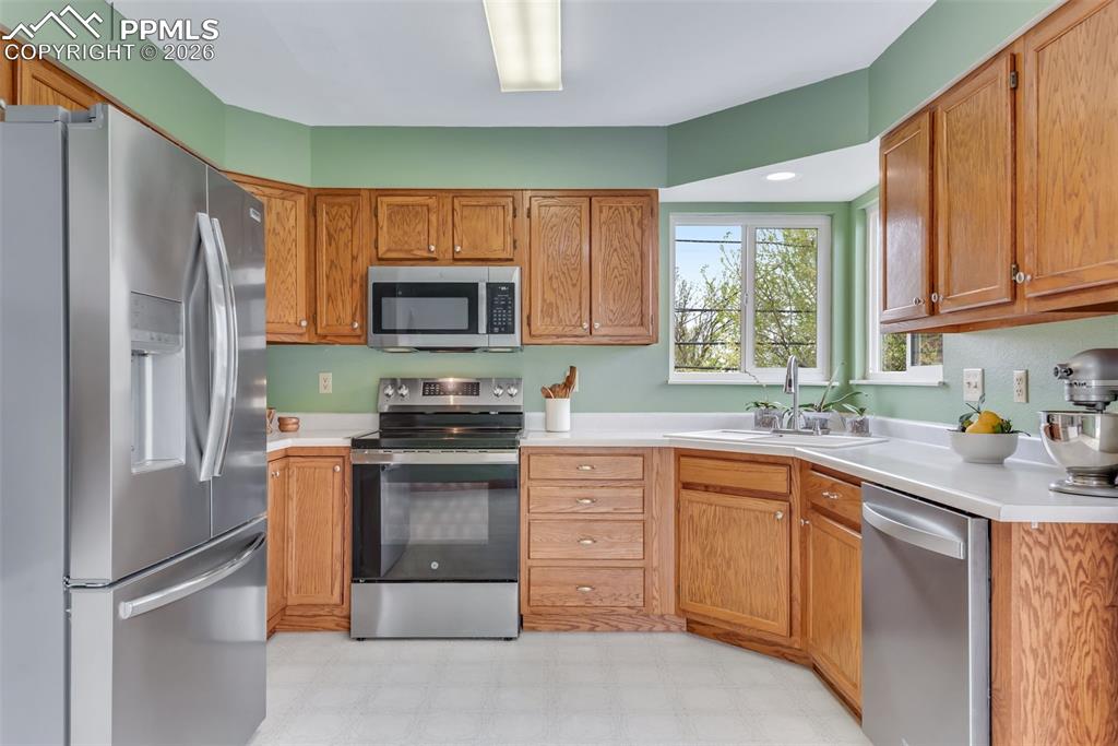 110 Monk Street Colorado Springs, CO 80911 - Photo 16 of 34 a kitchen with stainless steel appliances granite countertop a refrigerator stove and sink