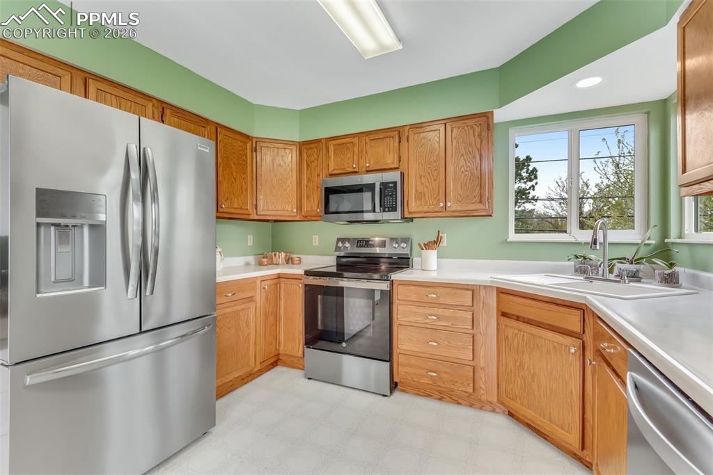 110 Monk Street Colorado Springs, CO 80911 - Photo 18 of 34 a kitchen with cabinets stainless steel appliances and a window