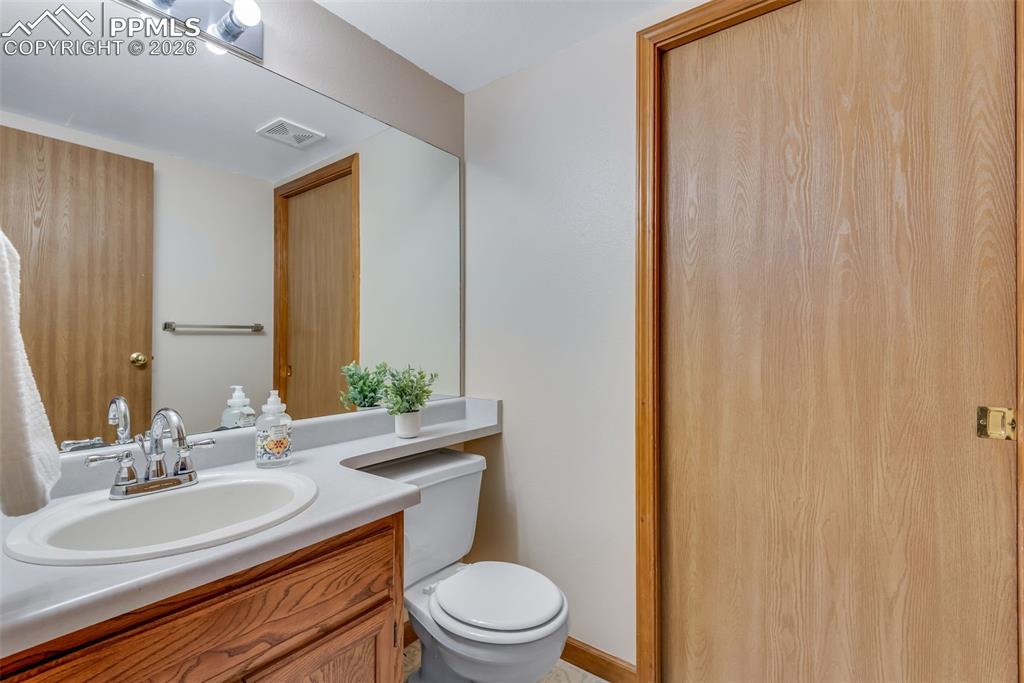 110 Monk Street Colorado Springs, CO 80911 - Photo 19 of 34 a bathroom with a sink a toilet and a mirror