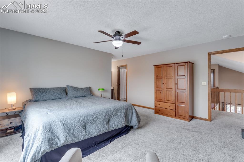 110 Monk Street Colorado Springs, CO 80911 - Photo 22 of 34 a bedroom with a bed chandelier and a window