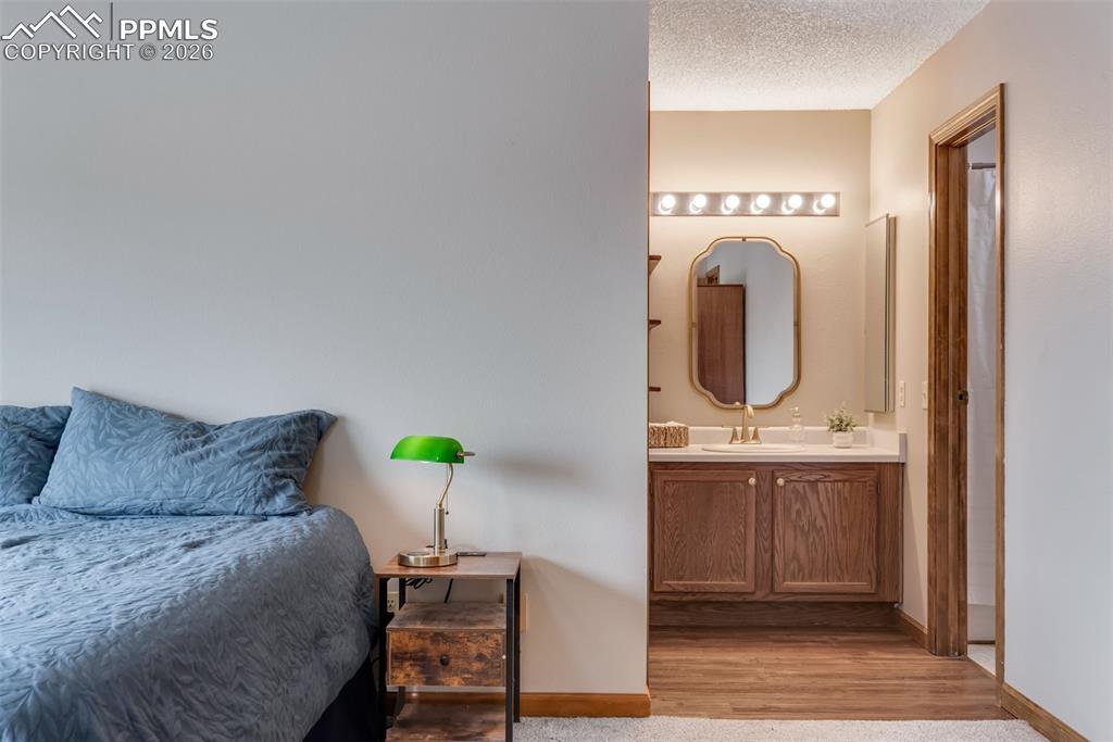 110 Monk Street Colorado Springs, CO 80911 - Photo 23 of 34 a bedroom with a bed and cabinet