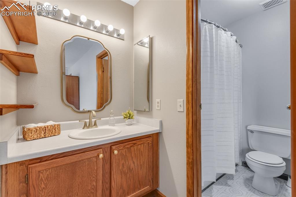 110 Monk Street Colorado Springs, CO 80911 - Photo 24 of 34 a bathroom with a double vanity sink and a mirror