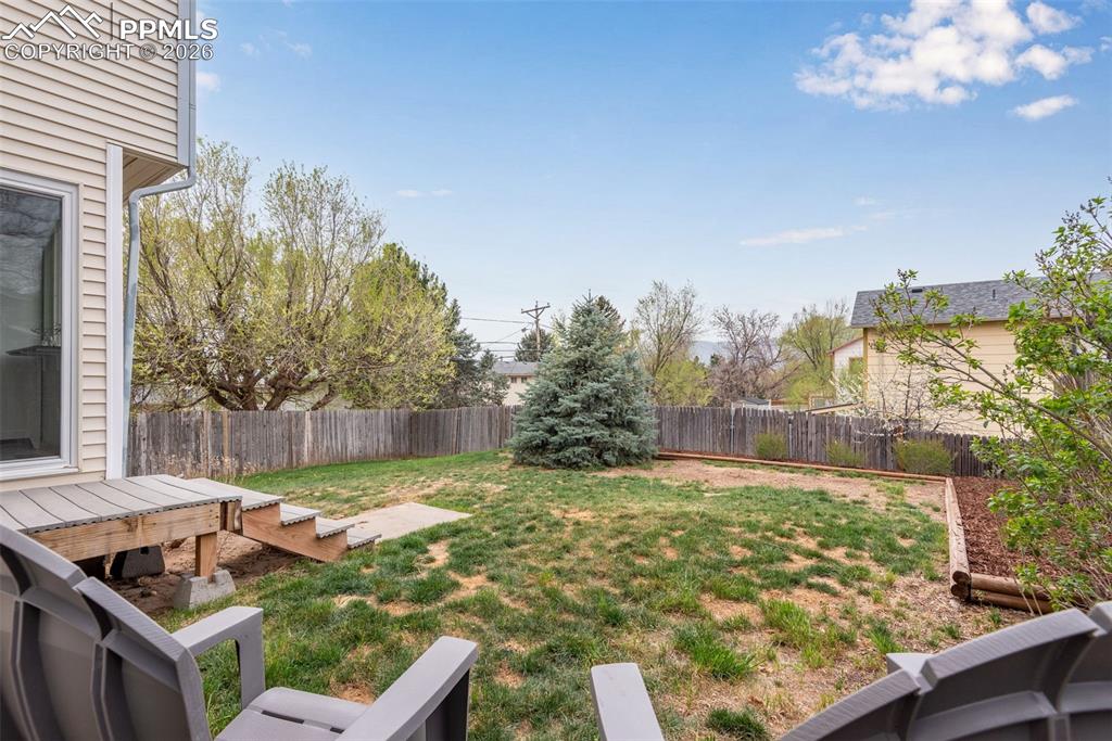 110 Monk Street Colorado Springs, CO 80911 - Photo 3 of 34 a view of a backyard with plants and a patio