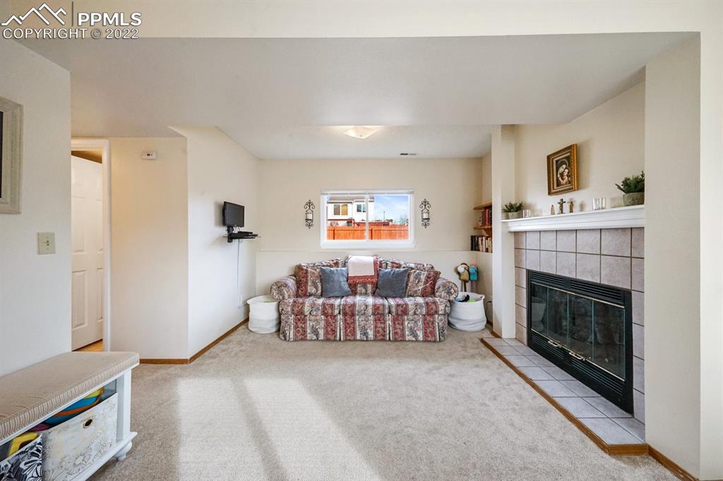 5805 Dutchess Drive Colorado Springs, CO 80923 - Photo 18 of 34 a living room with furniture and a fireplace