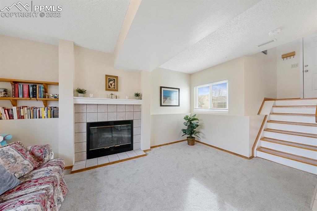 5805 Dutchess Drive Colorado Springs, CO 80923 - Photo 20 of 34 a living room with furniture and a fireplace