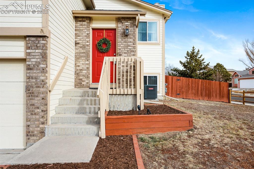5805 Dutchess Drive Colorado Springs, CO 80923 - Photo 2 of 34 a front view of a house with entertaining space