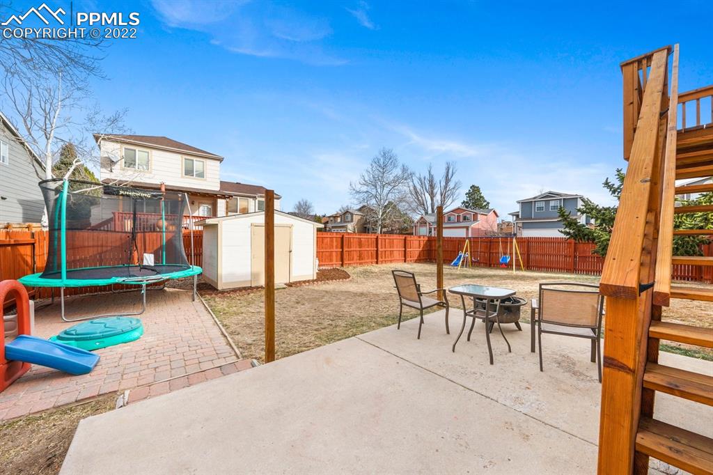 5805 Dutchess Drive Colorado Springs, CO 80923 - Photo 25 of 34 a view of a patio with a table and chairs