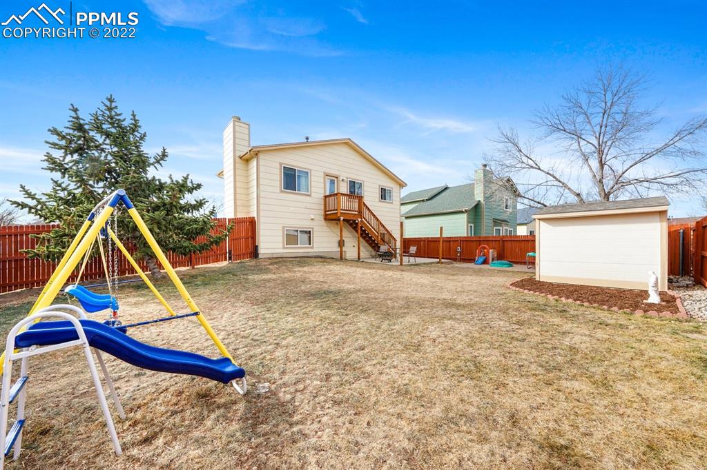5805 Dutchess Drive Colorado Springs, CO 80923 - Photo 26 of 34 a view of wooden house with a yard