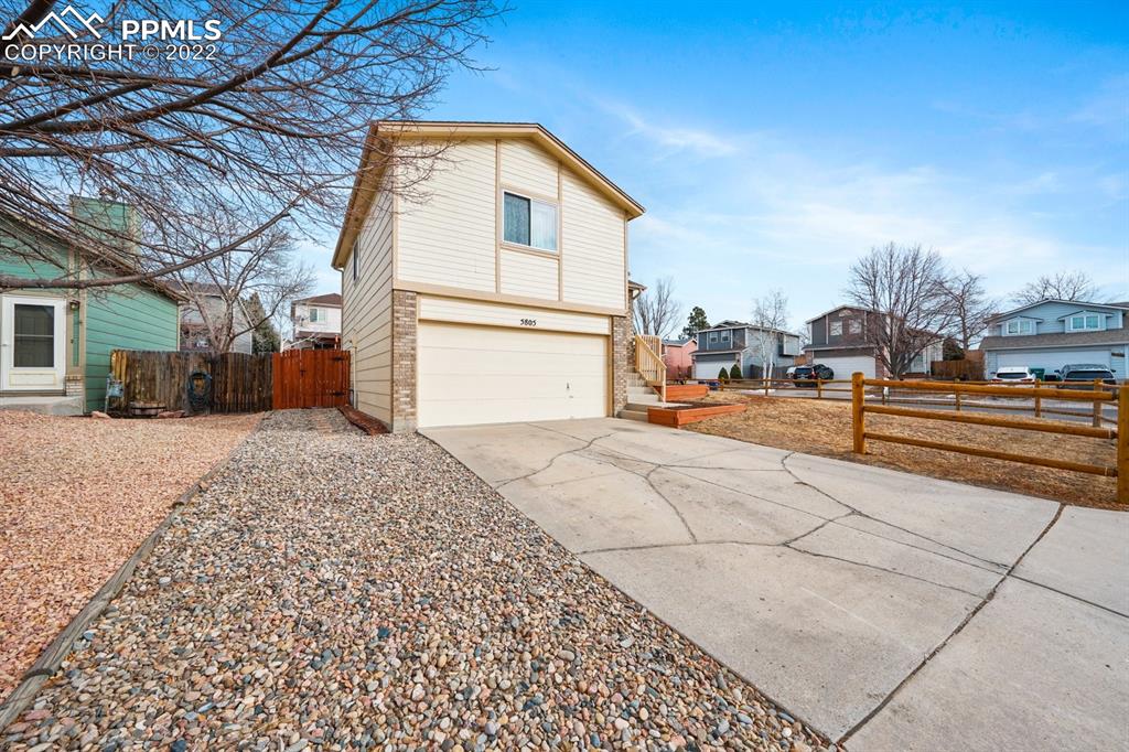 5805 Dutchess Drive Colorado Springs, CO 80923 - Photo 29 of 34 a view of a white house with a outdoor space